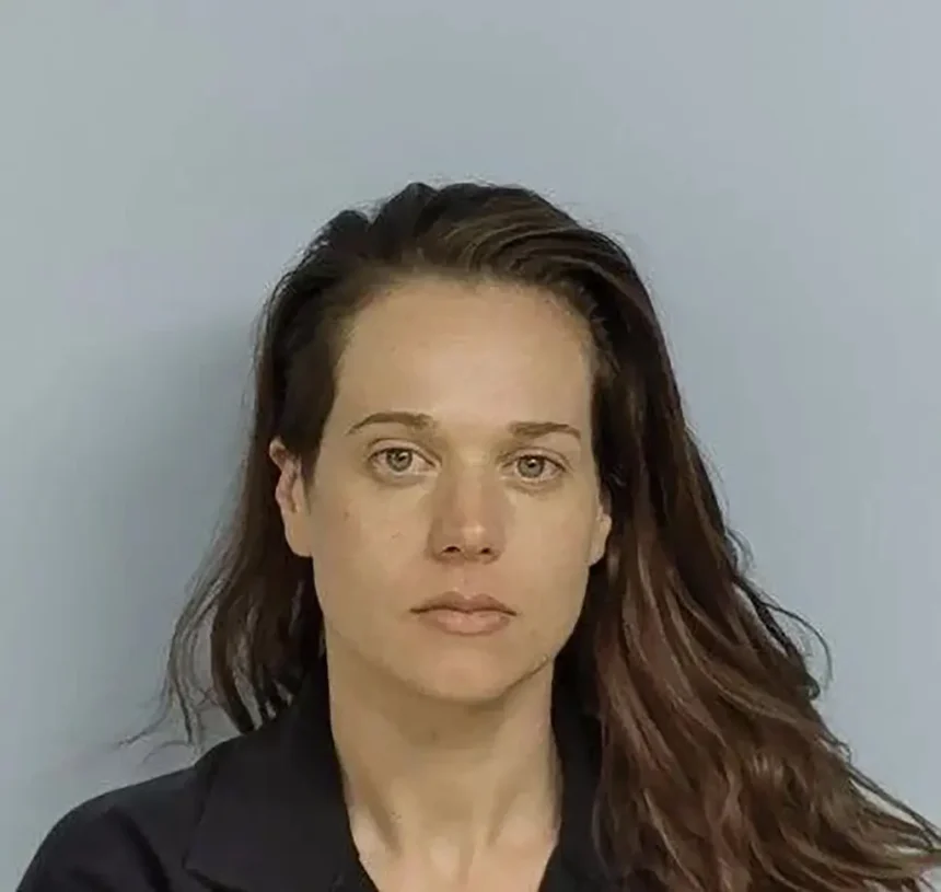 Woman accused of killing missing father found in shallow grave remains on the run, police say